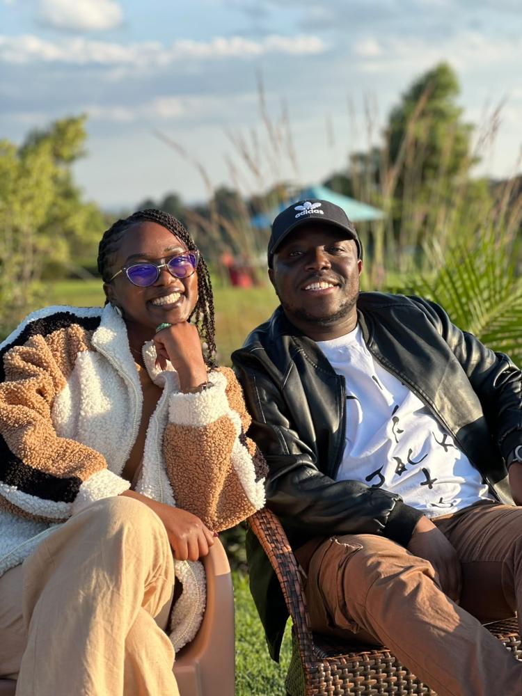 Tete and Ian seated in a garden at golden hour