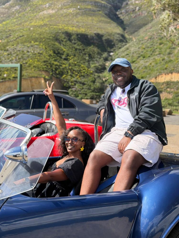 Tete and Ian in a blue vintage roadster